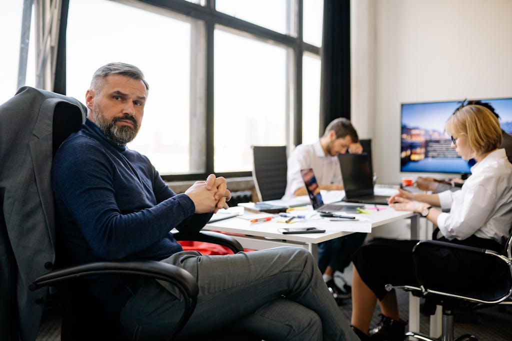 Co-workers engaging in a business discussion in a modern office setting.