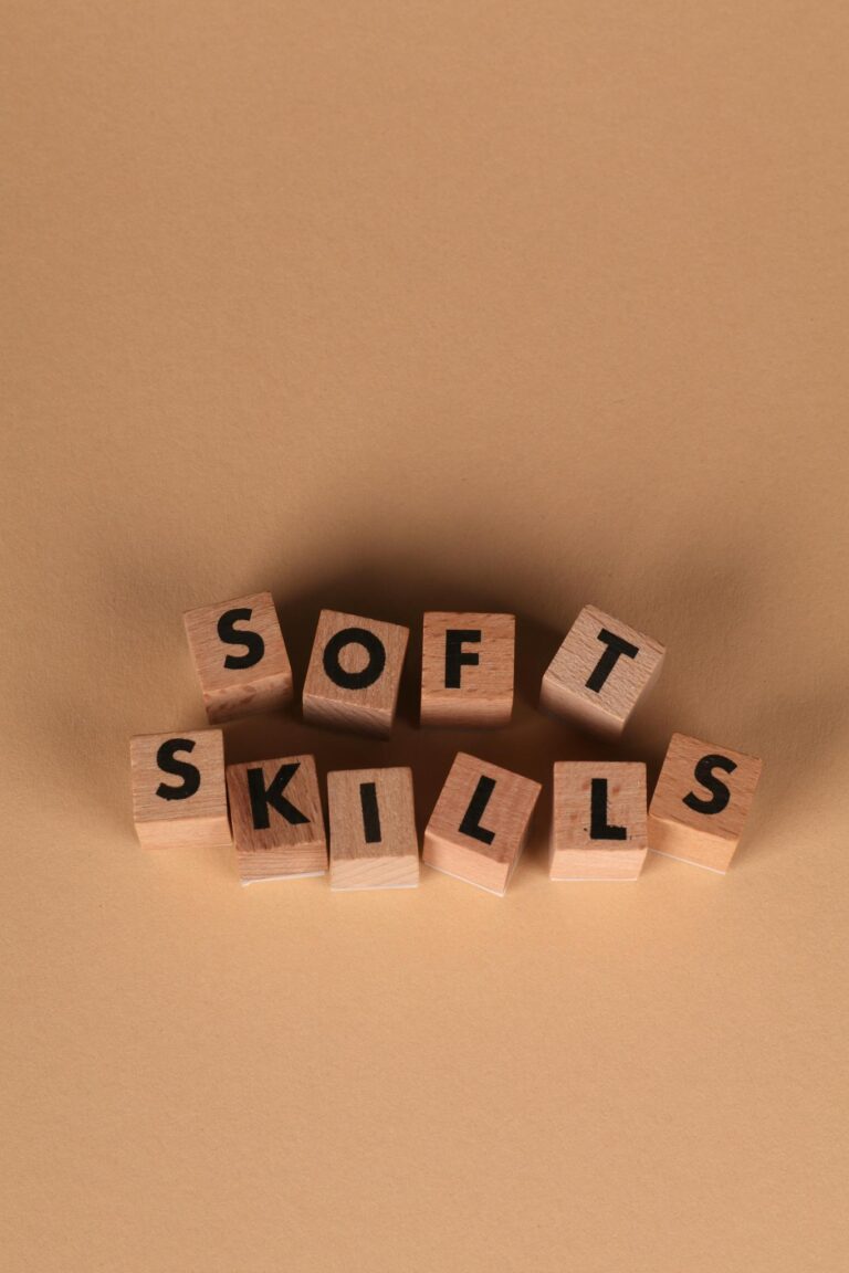 Wooden blocks arranged to spell 'Soft Skills' on a brown background