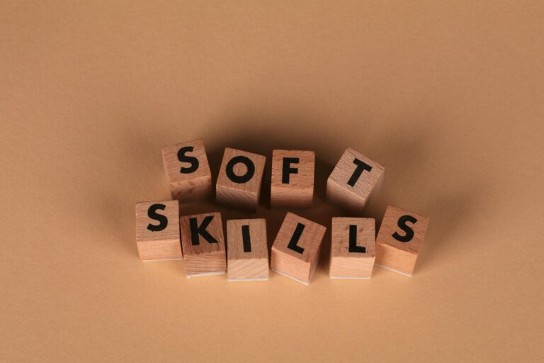 Wooden letter blocks spell out 'Soft Skills', highlighting business and personal development concepts.